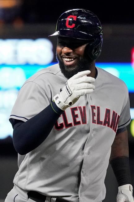 Cleveland Indians' Franmil Reyes smiles after crossing third base on his way home after his solo home run off Minnesota Twins pitcher Andrew Albers in the ninth inning of a baseball game, Wednesday, Sept. 15, 2021, in Minneapolis. The Indians won 12-3. (AP Photo/Jim Mone)