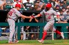 Los Angeles Angels' Jose Rojas, right, celebrates with third base coach Brian Butterfield after hitting a two-run home run during the fourth inning of a baseball game against the Chicago White Sox in Chicago, Thursday, Sept. 16, 2021. (AP Photo/Nam Y. Huh)