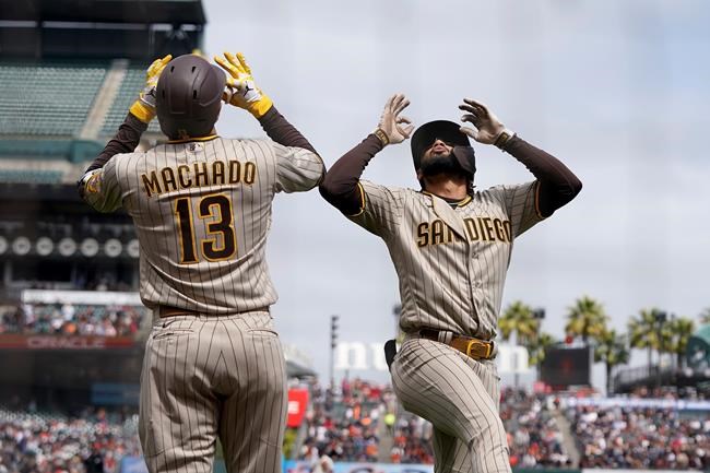 San Diego Padres' Fernando Tatis Jr., right, celebrates with Manny Machado after hitting a home run against the San Francisco Giants during the third inning of a baseball game in San Francisco, Thursday, Sept. 16, 2021. (AP Photo/Jeff Chiu)