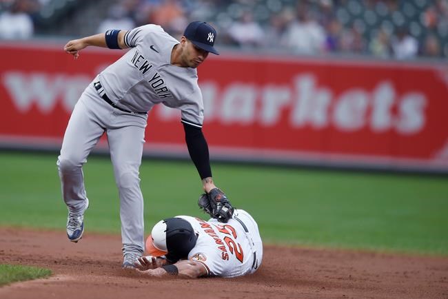 Baltimore Orioles' Anthony Santander is safe on a steal as New York Yankees second baseman Gleyber Torres tries to tag him during the third inning of a baseball game Thursday, Sept. 16, 2021, in Baltimore. (AP Photo/Gail Burton)