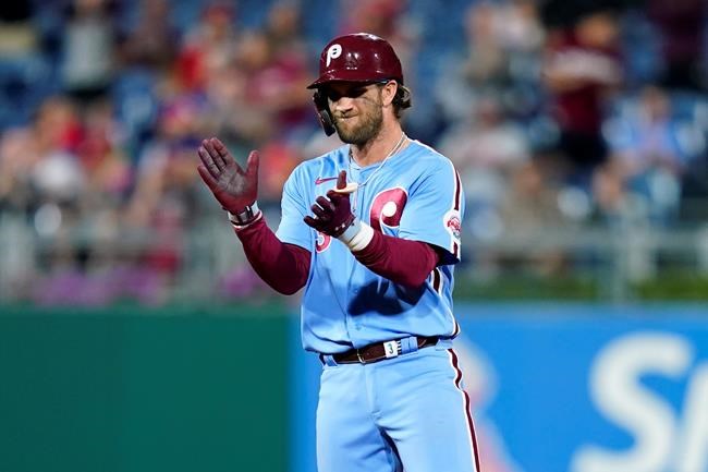 Philadelphia Phillies' Bryce Harper reacts after hitting an RBI-double against Chicago Cubs pitcher Manuel Rodriguez during the sixth inning of a baseball game, Thursday, Sept. 16, 2021, in Philadelphia. (AP Photo/Matt Slocum)