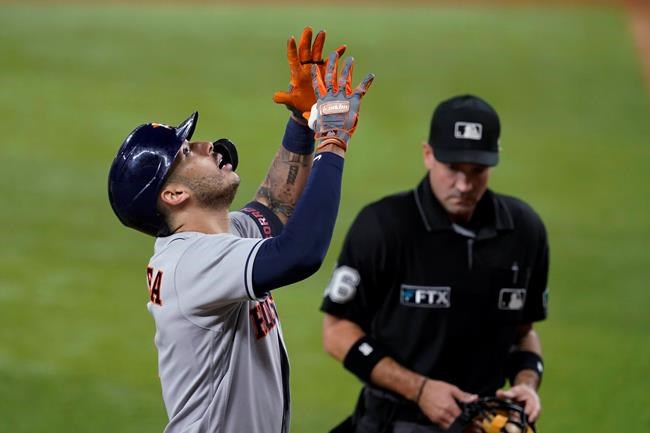 Houston Astros' Carlos Correa celebrates his three-run home run as umpire David Rackley watches Correa cross the plate during the fourth inning of the team's baseball game against the Texas Rangers in Arlington, Texas, Thursday, Sept. 16, 2021. (AP Photo/Tony Gutierrez)