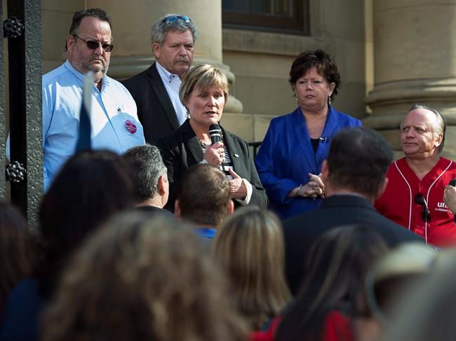 Janet Hazelton, president of the Nova Scotia Nurses' Union, accompanied by other pubic sector labour leaders, addresses workers as they protest the Liberal government's move to reorganize the administration of the province's health-care system, at the Nova Scotia legislature in Halifax on Friday, Sept. 26, 2014. Nova Scotia nurses are joining their unionized counterparts from across the country to rally against ongoing nursing shortages in the health system. THE CANADIAN PRESS/Andrew Vaughan