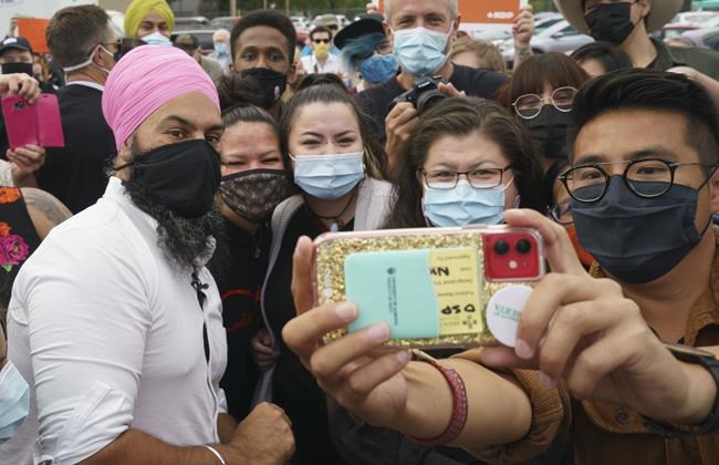 Local candidate Blake Desjarlais, right, takes a souvenir photo of NDP leader Jagmeet Singh and supporters during a campaign rally in Edmonton on Thursday, August 19, 2021. THE CANADIAN PRESS/Paul Chiasson