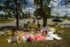 A woman visits the scene and a tribute to the victims of the deadly vehicle attack on five members of the Canadian Muslim community in London, Ont., on Monday, June 14, 2021. Many Muslim Canadians have shared feelings of anxiety after four members of a Muslim family out for an evening stroll were struck and killed by a vehicle in London, Ont., in what police have called an attack motivated by hate. THE CANADIAN PRESS/Nathan Denette