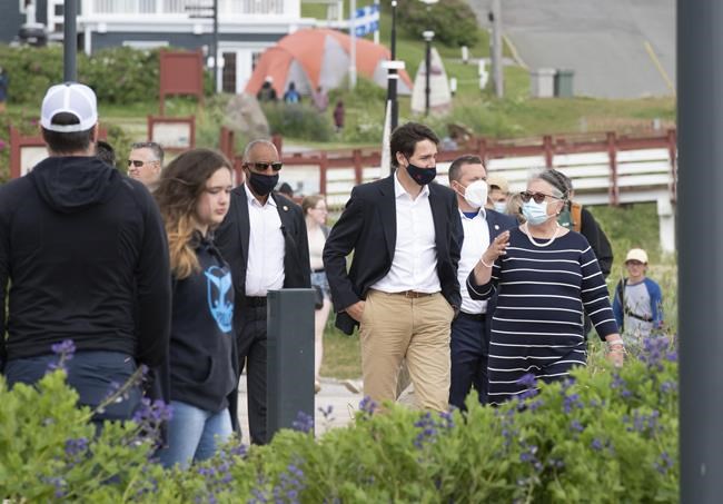 Prime Minister Justin Trudeau and Minister of National Revenue Diane Lebouthillier take a stroll on the boardwalk near the Perce rock, following a meeting on Wednesday, July 14, 2021 in Perce, Quebec. The Gaspésie region in eastern Quebec is best known to outsiders for its charming villages, outdoor recreation opportunities and panoramic views of the St-Lawrence river, but it could also become contested territory during a fall election.THE CANADIAN PRESS/Jacques Boissinot
