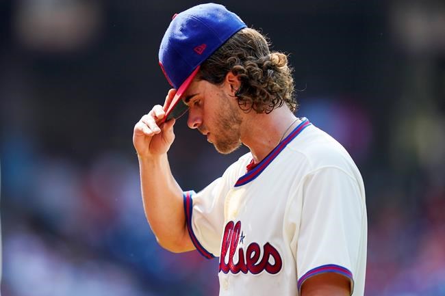 Philadelphia Phillies pitcher Aaron Nola walks off the field after the fifth inning of a baseball game against the Colorado Rockies, Sunday, Sept. 12, 2021, in Philadelphia. (AP Photo/Matt Slocum)