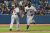 Minnesota Twins’ Miguel Sano (22) rounds the bases and shakes hands with third base coach Tony Diaz in the third inning of an American League baseball game against the Toronto Blue Jays in Toronto on Friday, Sept. 17, 2021. THE CANADIAN PRESS/Jon Blacker