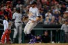 Colorado Rockies' Sam Hilliard (22) comes in to score on a single by Brendan Rodgers during the ninth inning of a baseball game against the Washington Nationals, Friday, Sept. 17, 2021, in Washington. Nationals catcher Keibert Ruiz, left, looks on. (AP Photo/Nick Wass)