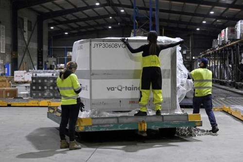 Airport workers check containers of the first shipment of the Moderna COVID-19 vaccination as it arrives in Sydney, Australia, Friday, Sept. 17, 2021. Moderna is the third type of COVID-19 vaccine to be used in Australia, with Pfizer and AstraZeneca already in use. (Bianca De Marchi/Pool Photo via AP)