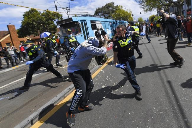 Victoria police clash with protesters during a Rally for Freedom in Melbourne, Australia, Saturday, Sept. 18, 2021. The protesters were demonstrating against the latest COVID-19 lockdown in Melbourne. (James Ross/AAP Image via AP)
