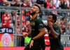 Munich's Eric Maxim Choupo-Moting, left, celebrates with Omar Richards after scoring his side's seventh goal during a German Bundesliga soccer match between Bayern Munich and VfL Bochum in Munich, Germany, Saturday, Sept.18, 2021. (Sven Hoppe/dpa via AP)