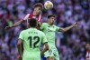 Atletico Madrid's Antoine Griezmann heads the ball past Athletic Bilbao's Unai Vencedor during a Spanish La Liga soccer match between Atletico Madrid and Athletic Bilbao at Wanda Metropolitano stadium in Madrid, Spain, Saturday, Sept. 18, 2021. (AP Photo/Manu Fernandez)