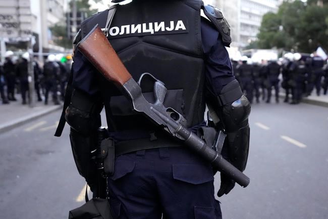 Serbian police guards the area as demonstrators take the streets to protest potential new COVID-19 restrictions announced by the government in Belgrade, Serbia, Saturday, Sept. 18, 2021. (AP Photo/Darko Vojinovic)