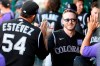 Colorado Rockies' Trevor Story, front right, celebrates his three-run home run with Carlos Estevez (54) and others in the dugout during the fourth inning of a baseball game against the Washington Nationals, Saturday, Sept. 18, 2021, in Washington. (AP Photo/Nick Wass)