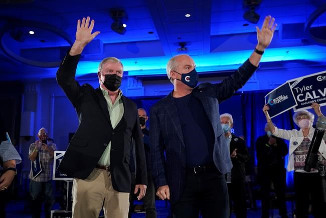 Conservative Leader Erin O'Toole, right, and retired general Rick Hillier wave to supporters at a campaign rally in Kitchener, Ont., Saturday, Sept. 18, 2021. THE CANADIAN PRESS/Adrian Wyld