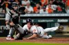 Houston Astros' Jake Meyers, right, scores as Arizona Diamondbacks catcher Daulton Varsho reaches for the ball during the 10th inning of a baseball game Saturday, Sept. 18, 2021, in Houston. (AP Photo/David J. Phillip)
