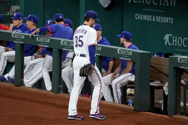 Texas Rangers starting pitcher Kohei Arihara (35) leaves the field after turning the ball over in the fifth inning of a baseball game against the Houston Astros in Arlington, Texas, Wednesday, Sept. 15, 2021. (AP Photo/Tony Gutierrez)