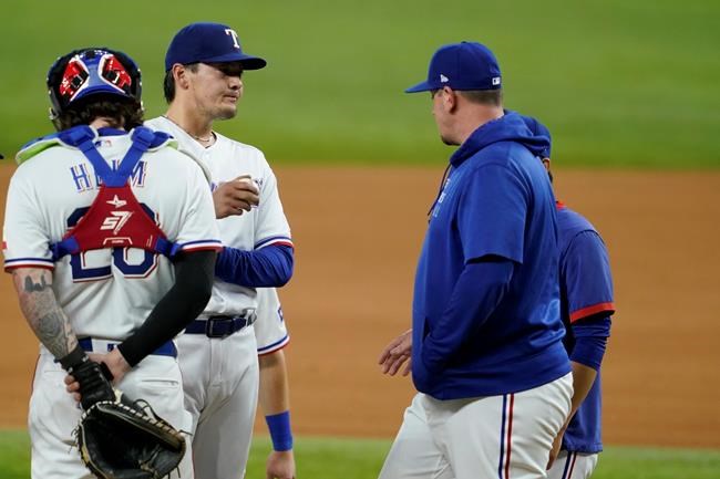 Texas Rangers catcher Jonah Heim (28) stands by as starting pitcher Kohei Arihara, second from left, gets a visit from pitching coach Doug Mathis, right, in the fifth inning of a baseball game against the Houston Astros in Arlington, Texas, Wednesday, Sept. 15, 2021. (AP Photo/Tony Gutierrez)