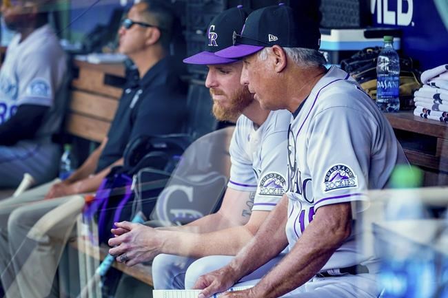 Colorado Rockies manager Bud Black, right, speaks with starting pitcher Jon Gray, left, in the dugout during the fifth inning of a baseball game against the Washington Nationals at Nationals Park, Sunday, Sept. 19, 2021, in Washington. (AP Photo/Andrew Harnik)