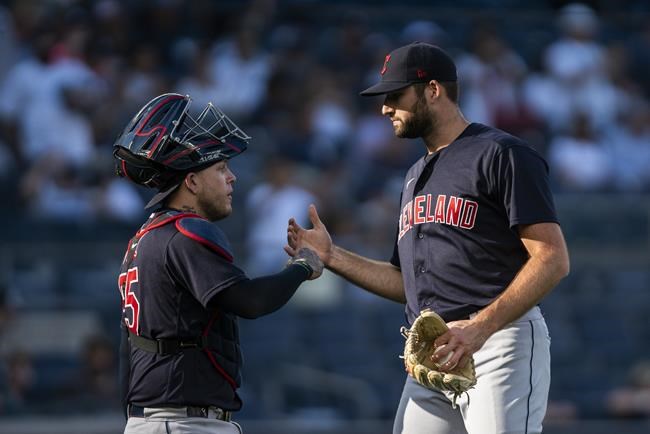 Cleveland Indians relief pitcher Sam Hentges, left, celebrates with catcher Roberto Perez after defeating the New York Yankees in a baseball game Sunday, Sept. 19, 2021, in New York. (AP Photo/Eduardo Munoz Alvarez)
