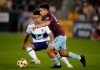 Colorado Rapids midfielder Braian Galvan, front, pursues the bal with Vancouver Whitecaps midfielder Michael Baldisimo in the second half of an MLS soccer match Sunday, Sept. 19, 2021, in Commerce City, Colo. The game ended in a 1-1 tie. (AP Photo/David Zalubowski)