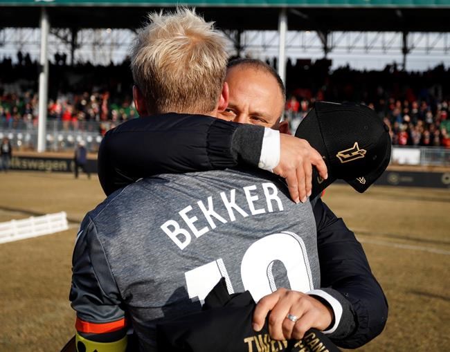 Hamilton Forge's head coach Bobby Smyrniotis, right, hugs captain Kyle Bekker following their victory in the Canadian Premier League soccer final against the Calgary Cavalry in Calgary, Saturday, Nov. 2, 2019. THE CANADIAN PRESS/Jeff McIntosh