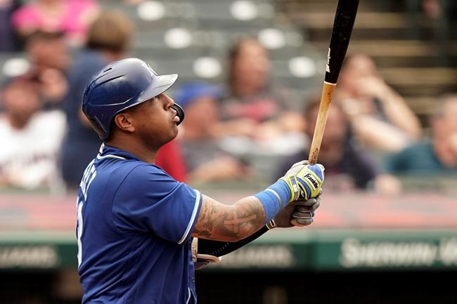 Kansas City Royals' Salvador Perez watches his two-run home run in the fifth inning in the first baseball game of a doubleheader against the Cleveland Indians, Monday, Sept. 20, 2021, in Cleveland. The home run broke Johnny Bench's record for the most home runs in a season by a primary catcher. (AP Photo/Tony Dejak)