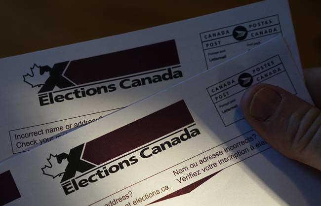 A person holds an Elections Canada voter information card after receiving it in the mail on Tuesday, Aug 31, 2021. THE CANADIAN PRESS/Sean Kilpatrick