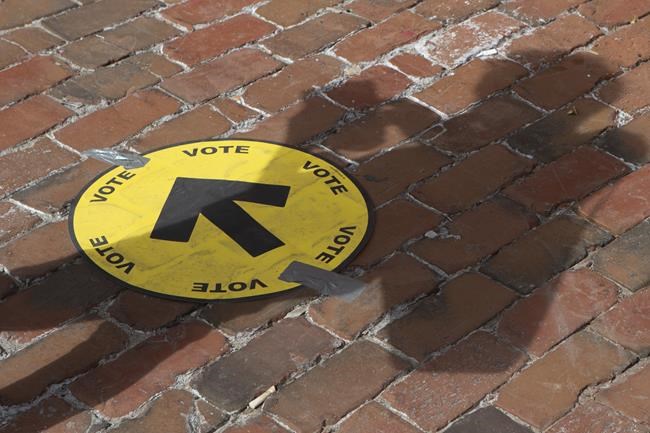 A voter queues at a poling station to cast their ballot in Toronto's Spadina-Fort York district on Monday September 20 , 2021. THE CANADIAN PRESS/Chris Young