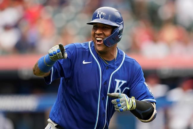 Kansas City Royals' Salvador Perez smiles and points to the dugout after hitting a two-run home run in the fifth inning in the first baseball game of a doubleheader against the Cleveland Indians, Monday, Sept. 20, 2021, in Cleveland. The home run broke Johnny Bench's record for the most home runs in a season by a primary catcher. (AP Photo/Tony Dejak)