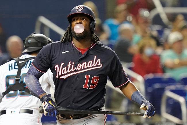 Washington Nationals' Josh Bell (19) blows a bubble after striking out in the second inning of a baseball game against the Miami Marlins, Monday, Sept. 20, 2021, in Miami. (AP Photo/Marta Lavandier)