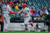 St. Louis Cardinals' Nolan Arenado (28) is congratulated by third base coach Ron 'Pop' Warner (75) after hitting a two-run home run during the first inning of a baseball game against the Milwaukee Brewers, Monday, Sept. 20, 2021, in Milwaukee. (AP Photo/Aaron Gash)