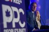People's Party of Canada Leader Maxime Bernier and wife Catherine Letarte speaks from a podium to supporters during the PPC headquarters election night event in Saskatoon, Sask., Monday, Sept. 20, 2021. THE CANADIAN PRESS/Liam Richards