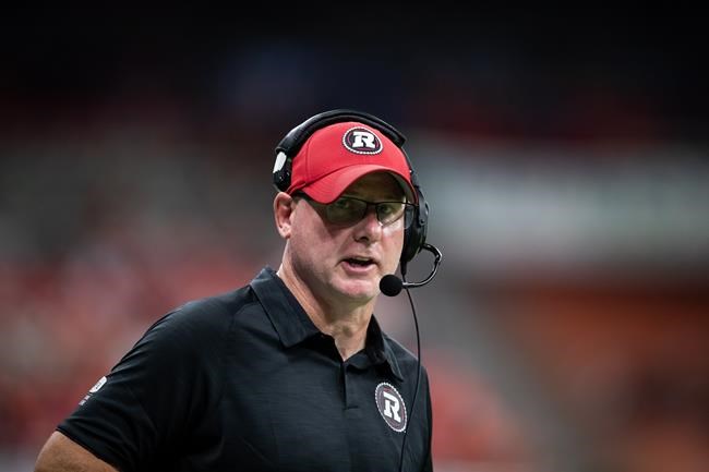 Ottawa Redblacks head coach Paul LaPolice stands on the sideline during the second half of a CFL football game against the B.C. Lions in Vancouver, on September 11, 2021. THE CANADIAN PRESS/Darryl Dyck