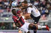 Bologna's Musa Barrow, left, competes for the ball with Genoa's Mattia Bani during the Serie A soccer match between Bologna and Genoa, at the Renato Dall'Ara stadium in Bologna, Italy, Tuesday, Sept. 21, 2021. (Massimo Paolone/LaPresse via AP)