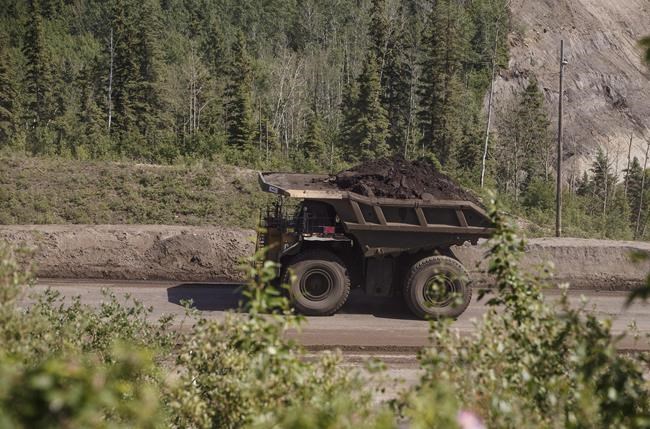 A heavy hauler truck transports material from Suncor's North Steepbank in the oil sands in Fort McMurray, Alta., Monday, June 13, 2017. THE CANADIAN PRESS/Jason Franson