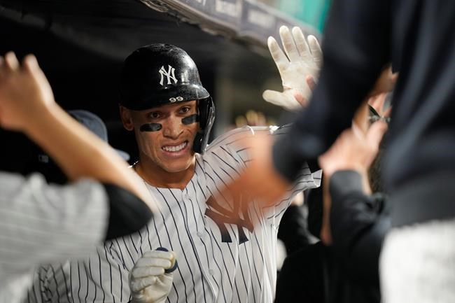 New York Yankees' Aaron Judge celebrates with teammates after hitting a three-run home run during the seventh inning of a baseball game against the Texas Rangers Tuesday, Sept. 21, 2021, in New York. (AP Photo/Frank Franklin II)