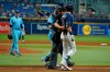 Tampa Bay Rays' Kevin Kiermaier, right, is held back by home plate umpire Bruce Dreckman and Toronto Blue Jays catcher Danny Jansen after Kiermaier was hit with a pitch by starting pitcher Ryan Borucki, right, during the eighth inning of a baseball game Wednesday, Sept. 22, 2021, in St. Petersburg, Fla. (AP Photo/Chris O'Meara)
