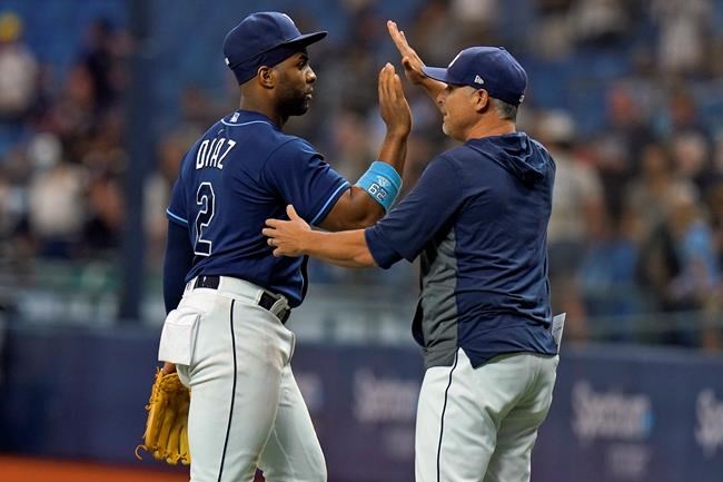 Tampa Bay Rays' Yandy Diaz (2) celebrates with manager Kevin Cash after the Rays defeated the Toronto Blue Jays during a baseball game Wednesday, Sept. 22, 2021, in St. Petersburg, Fla. (AP Photo/Chris O'Meara)