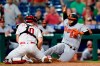 Baltimore Orioles' Pedro Severino, right, is tagged out at home by Philadelphia Phillies catcher J.T. Realmuto after trying to score on a single by Pat Valaika during the eighth inning of an interleague baseball game, Wednesday, Sept. 22, 2021, in Philadelphia. (AP Photo/Matt Slocum)