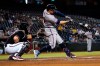 Atlanta Braves' Adam Duvall connects for a two run home run against the Arizona Diamondbacks during the first inning of a baseball game, Wednesday, Sept. 22, 2021, in Phoenix. (AP Photo/Matt York)