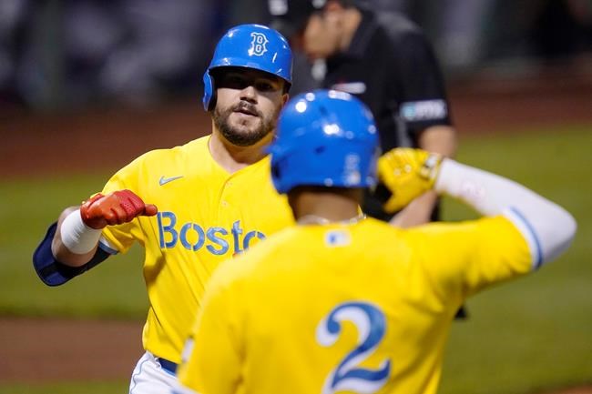 Boston Red Sox's Kyle Schwarber, left, is congratulated by Xander Bogaerts (2) after his solo home run off New York Mets starting pitcher Taijuan Walker during the first inning of a baseball game at Fenway Park, Wednesday, Sept. 22, 2021, in Boston. (AP Photo/Charles Krupa)