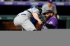 Los Angeles Dodgers catcher Will Smith, front, applies a late tag as Colorado Rockies' Charlie Blackmon scores on a double hit by C.J. Cron in the seventh inning of a baseball game Wednesday, Sept. 22, 2021, in Denver. (AP Photo/David Zalubowski)