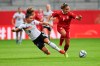 Germany's Lena Sophie Oberdorf, left, challenges for the ball with Serbia's Nina Matejic during the women soccer World Cup qualification match between Germany and Serbia in Chemnitz, Germany, Tuesday, Sept. 21, 2021. (Hendrik Schmidt/dpa via AP)