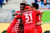 Mainz players celebrate their opening goal during a German Bundesliga soccer match between TSG 1899 Hoffenheim and FSV Mainz 05 in Sinsheim, Germany, Saturday, Sept.11, 2021. (Uwe Anspach/dpa via AP)