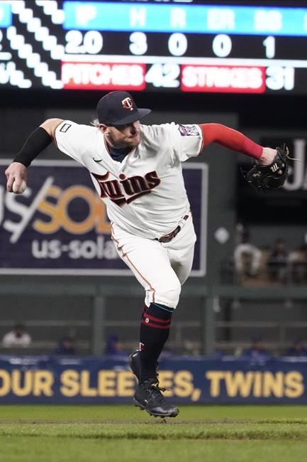 Minnesota Twins third baseman Josh Donaldson fields a grounder by Toronto Blue Jays' Vladimir Guerrero Jr. who beats the throw for a single in the second inning of a baseball game, Thursday, Sept. 23, 2021, in Minneapolis. (AP Photo/Jim Mone)