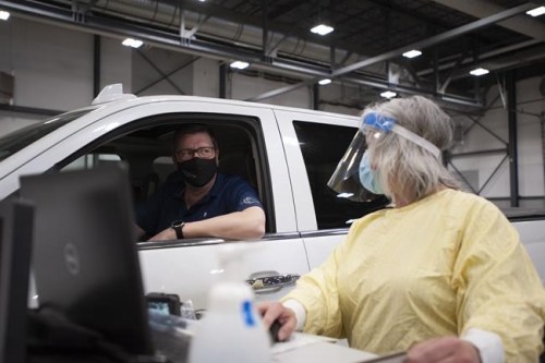Saskatchewan Premier Scott Moe registers for a dose of the Pfizer-BioNTech vaccine at a COVID-19 vaccination drive-thru clinic at Evraz Place in Regina on Thursday, April 15, 2021. THE CANADIAN PRESS/Mark Taylor