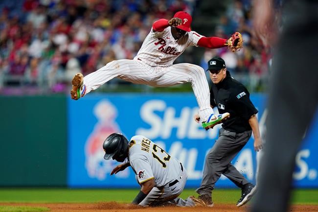 Pittsburgh Pirates' Ke'Bryan Hayes, bottom, steals second base under Philadelphia Phillies shortstop Didi Gregorius during the seventh inning of a baseball game, Friday, Sept. 24, 2021, in Philadelphia. (AP Photo/Matt Slocum)