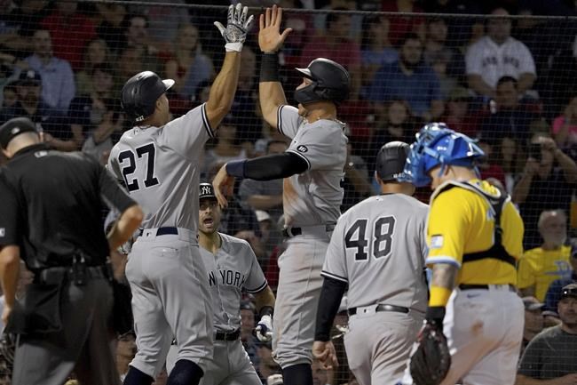 New York Yankees designated hitter Giancarlo Stanton (27) celebrates with Aaron Judge after hitting him in on a three-run home run during the third inning of a baseball game against the Boston Red Sox at Fenway Park, Friday, Sept. 24, 2021, in Boston. (AP Photo/Mary Schwalm)